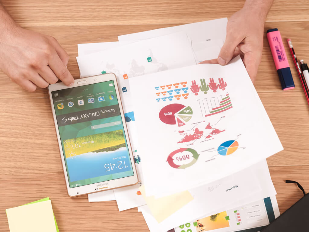 image of stats of company with phone and paper